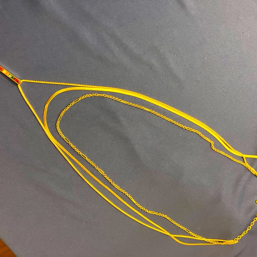 Kendra Scott triple strand gold necklace with multi colored pendant.